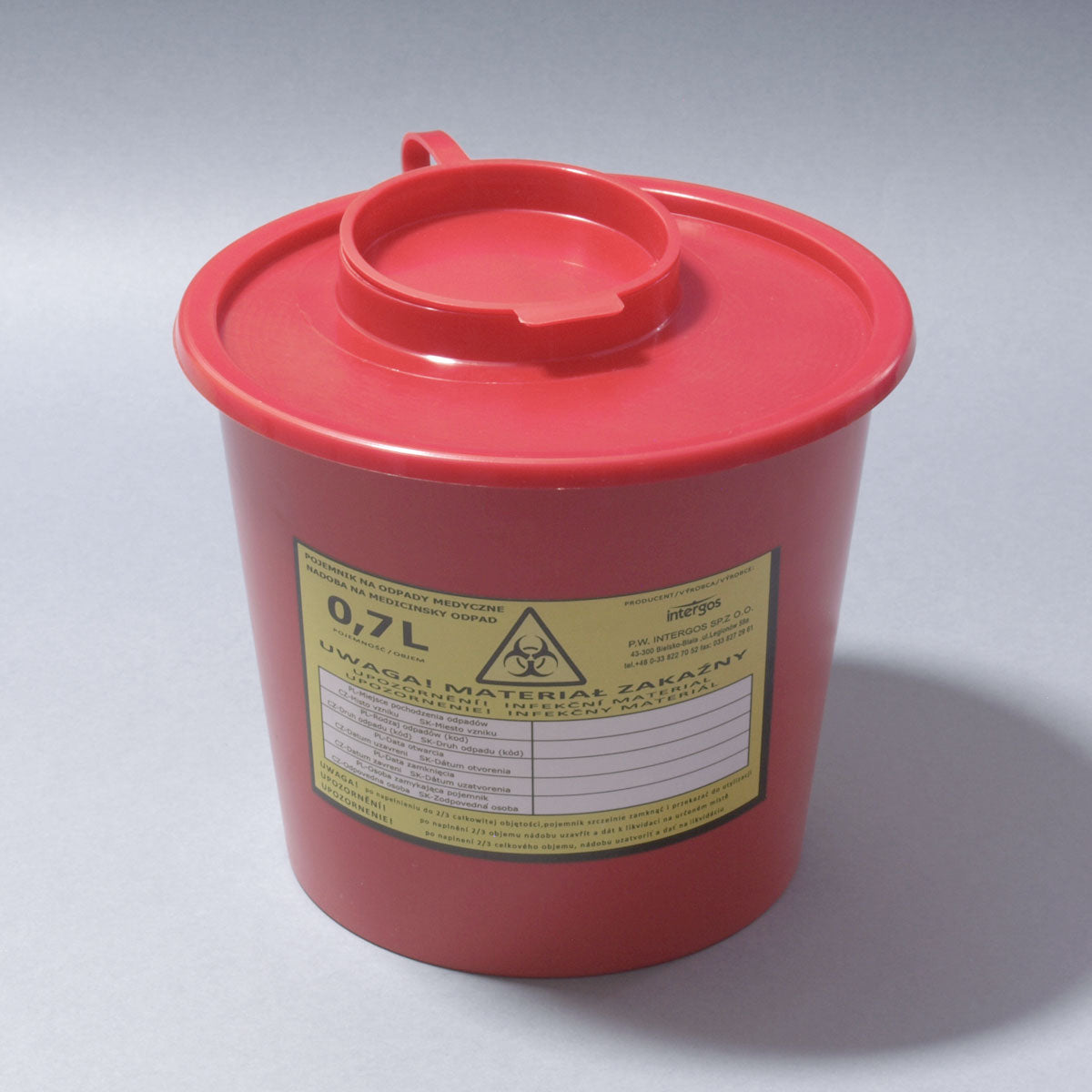 Red sharps container with a lid and warning label on a gray background,  zerohoursupply.eu